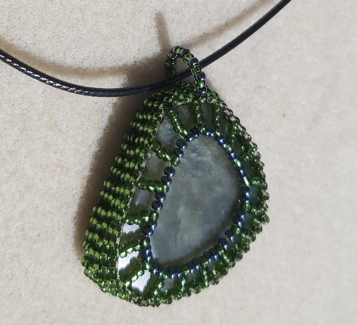 Approx. 70cts of Labradorite Gemstone wrapped in 11/O Olive Seed beads, with 18" Black Cord Chain.