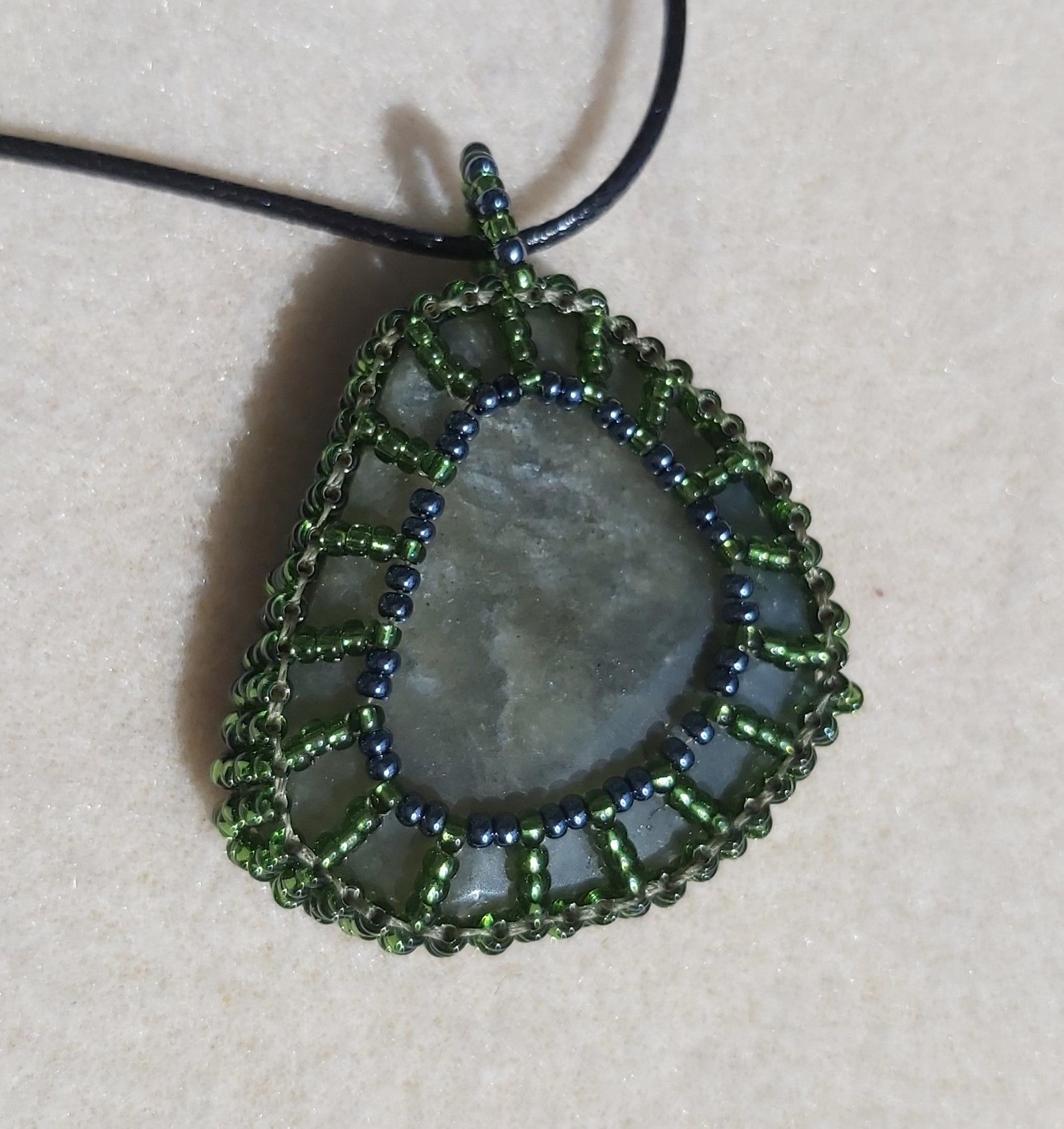 Approx. 70cts of Labradorite Gemstone wrapped in 11/O Olive Seed beads, with 18" Black Cord Chain.